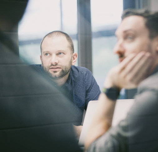 JSA team members in meeting room having a conversation